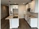 Well-lit kitchen with white cabinets, a kitchen island with a sink, and a stainless steel microwave at 5099 Prairie Preserve Run, St Cloud, FL 34772