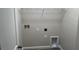 Laundry room featuring tile floor, connections for a washer and dryer, and a storage shelf at 5099 Prairie Preserve Run, St Cloud, FL 34772