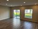 Bright and airy living area with tile floors, recessed lighting, and sliding glass doors to patio at 5099 Prairie Preserve Run, St Cloud, FL 34772