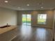 Bright living room featuring tile floors, recessed lighting, and backyard views from sliding glass doors at 5099 Prairie Preserve Run, St Cloud, FL 34772