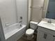 Bathroom featuring a shower-tub, toilet, large mirror, and vanity with white cabinets at 5103 Prairie Preserve Run, St Cloud, FL 34772
