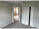 Bedroom with neutral walls and carpeted floor, featuring a closet at 5103 Prairie Preserve Run, St Cloud, FL 34772