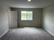 Bright bedroom with carpet, a window with a view, and natural light at 5103 Prairie Preserve Run, St Cloud, FL 34772