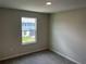 Bedroom with neutral walls and carpeted floor, featuring a window at 5103 Prairie Preserve Run, St Cloud, FL 34772
