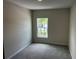Bedroom with neutral walls and carpeted floor, featuring a window at 5103 Prairie Preserve Run, St Cloud, FL 34772