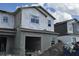 New construction home featuring an attached garage and partially finished exterior under a cloudy sky at 5103 Prairie Preserve Run, St Cloud, FL 34772