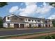 Rendering of townhomes with garages, stone accents and neutral color scheme with colored doors at 5103 Prairie Preserve Run, St Cloud, FL 34772