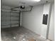 Spacious two-car garage featuring white block walls and concrete flooring at 5103 Prairie Preserve Run, St Cloud, FL 34772