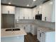 Modern kitchen with white cabinets, stainless steel appliances, and quartz countertops at 5103 Prairie Preserve Run, St Cloud, FL 34772