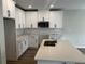Bright kitchen featuring white cabinets, quartz countertops, stainless appliances and wood floors at 5103 Prairie Preserve Run, St Cloud, FL 34772