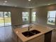 Bright living room featuring wood-look floors, access to the backyard and multiple windows at 5103 Prairie Preserve Run, St Cloud, FL 34772