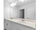 Bathroom with double sink vanity, granite countertops, a large mirror, and modern lighting at 5109 Forget Me Not Ave, Lake Hamilton, FL 33851