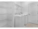 Bright laundry room features wire shelving, tile floors, and modern washer and dryer at 5109 Forget Me Not Ave, Lake Hamilton, FL 33851