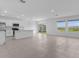 Open living area with a modern kitchen, tile flooring, and sliding glass doors at 5109 Forget Me Not Ave, Lake Hamilton, FL 33851