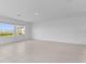 A spacious living room includes tile flooring, multiple windows, and neutral-colored walls perfect for various design styles at 5109 Forget Me Not Ave, Lake Hamilton, FL 33851