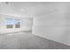 Open concept living area features plush carpeting and large windows with an abundance of natural light at 5109 Forget Me Not Ave, Lake Hamilton, FL 33851