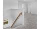 Upstairs landing showing carpeted floor, wooden banister, staircase, and open view to other rooms at 5109 Forget Me Not Ave, Lake Hamilton, FL 33851