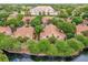 Aerial view of condo complex featuring multiple buildings and lush landscaping at 5452 E Michigan St # 7, Orlando, FL 32812