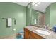 Well-lit bathroom with granite countertop vanity, neutral wall color, and accessible shower at 5452 E Michigan St # 7, Orlando, FL 32812