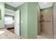 Neutral tiled shower with open doorway to bedroom at 5452 E Michigan St # 7, Orlando, FL 32812