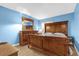 Bedroom with wooden furniture set, including bed, dresser, and mirror at 5452 E Michigan St # 7, Orlando, FL 32812
