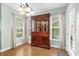 Dining room with wood floors, large china cabinet, and natural light from large windows at 5452 E Michigan St # 7, Orlando, FL 32812