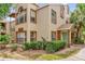 Inviting two-story home with a manicured lawn and lush landscaping at 5452 E Michigan St # 7, Orlando, FL 32812