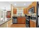 Modern kitchen with stainless steel appliances and breakfast bar at 5452 E Michigan St # 7, Orlando, FL 32812