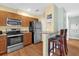 Functional kitchen featuring stainless steel appliances and a breakfast bar at 5452 E Michigan St # 7, Orlando, FL 32812