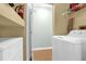 Laundry room with a washer and dryer set, shelves, and storage space at 5452 E Michigan St # 7, Orlando, FL 32812
