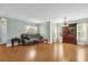 Open living space with hardwood flooring, gray sofa, and entertainment center at 5452 E Michigan St # 7, Orlando, FL 32812
