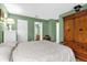 Comfortable main bedroom with hardwood floors and classic wooden furniture at 5452 E Michigan St # 7, Orlando, FL 32812