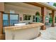 Outdoor poolside bar area with grill, tile countertop and seating, adjacent to the entrance and pool rules at 5452 E Michigan St # 7, Orlando, FL 32812