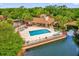 Aerial view of community pool overlooking tranquil waterfront, complete with lounge chairs and well maintained landscaping at 5452 E Michigan St # 7, Orlando, FL 32812