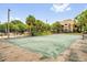 Well maintained tennis court featuring a green surface and black fencing, situated near the community pool at 5452 E Michigan St # 7, Orlando, FL 32812