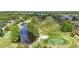 Scenic aerial view of the golf course, serene pond and lush green surroundings for a relaxing outdoor experience at 5489 Baldwin Park St, Orlando, FL 32814