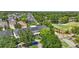Aerial view showcases a townhome with lush green surroundings and a golf course nearby at 5489 Baldwin Park St, Orlando, FL 32814