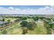 Wide aerial shot of the lush golf course with mature trees and scenic water features, offering stunning views at 5489 Baldwin Park St, Orlando, FL 32814