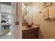 Stylish powder room with a vessel sink, bronze faucet, granite countertop and modern lighting fixtures at 5489 Baldwin Park St, Orlando, FL 32814