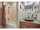 Bathroom features a tub with shower, tile surround, and a vanity with a vessel sink at 5489 Baldwin Park St, Orlando, FL 32814