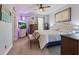 Spacious bedroom with a comfortable bed, dresser, and ample natural light at 5489 Baldwin Park St, Orlando, FL 32814