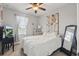 Charming bedroom with a full bed, soft natural lighting, and minimalist decor at 5489 Baldwin Park St, Orlando, FL 32814