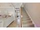 Inviting foyer with staircase, tile floors, and view into a beautifully furnished living room at 5489 Baldwin Park St, Orlando, FL 32814