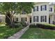 Charming townhome showcasing lush landscaping, a welcoming walkway, and classic black shutters at 5489 Baldwin Park St, Orlando, FL 32814