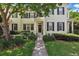 Charming two-story home with a landscaped front yard and inviting entrance, enhanced by a mature tree at 5489 Baldwin Park St, Orlando, FL 32814