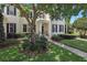 Charming two-story home with a landscaped front yard and inviting entrance, enhanced by a mature tree at 5489 Baldwin Park St, Orlando, FL 32814
