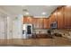 Modern kitchen featuring stainless steel appliances, wooden cabinets and granite countertops for a modern look at 5489 Baldwin Park St, Orlando, FL 32814