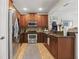 Well-equipped kitchen with stainless steel appliances, wooden cabinets, and tiled backsplash for easy maintenance at 5489 Baldwin Park St, Orlando, FL 32814