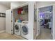 Convenient laundry closet equipped with modern washer and dryer units at 5489 Baldwin Park St, Orlando, FL 32814