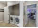 Convenient laundry closet with washer and dryer, located adjacent to the bedroom at 5489 Baldwin Park St, Orlando, FL 32814